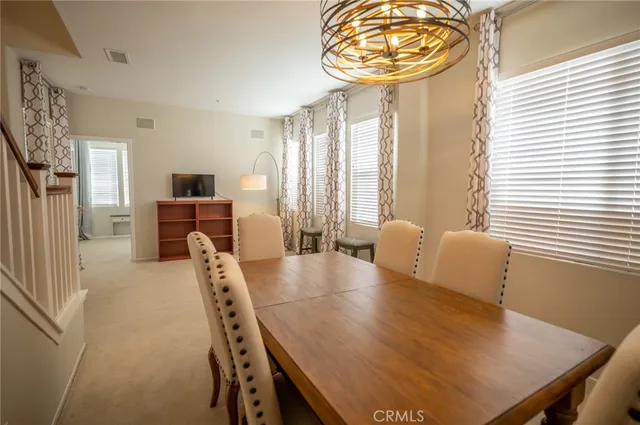 a view of a dining room with furniture and a large window