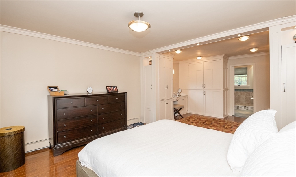 25 Ellen Road Stoneham, MA 02180 - Photo 30 of 41 a bedroom with a bed and wooden floor