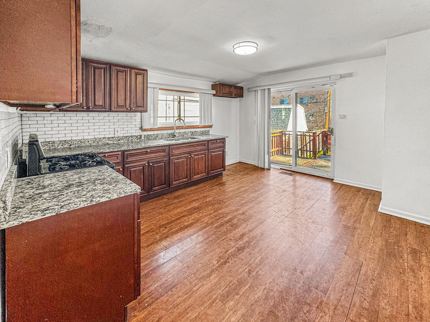 13059 Honore Street Blue Island, IL 60406 - Photo 5 of 15 a kitchen with stainless steel appliances granite countertop a stove a sink dishwasher and a refrigerator with wooden floor