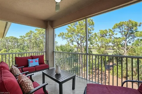 a balcony with furniture and a potted plant