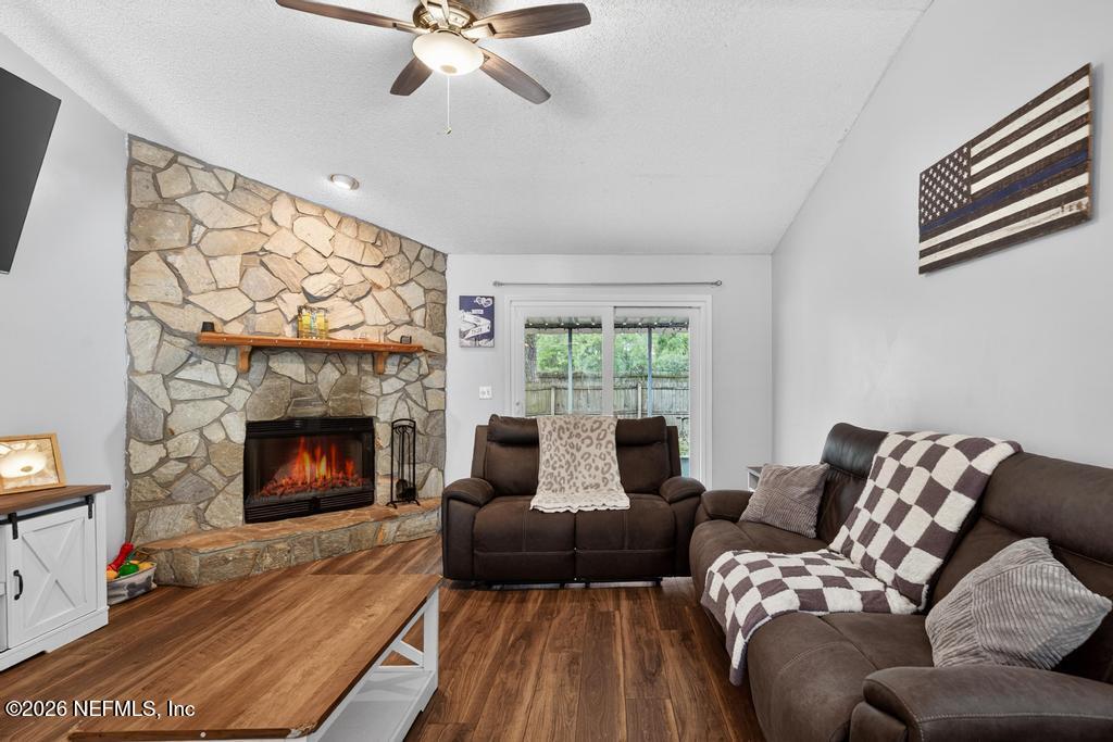 86093 Santa Barbara Street Yulee, FL 32097 - Photo 25 of 51 a living room with furniture and a fireplace
