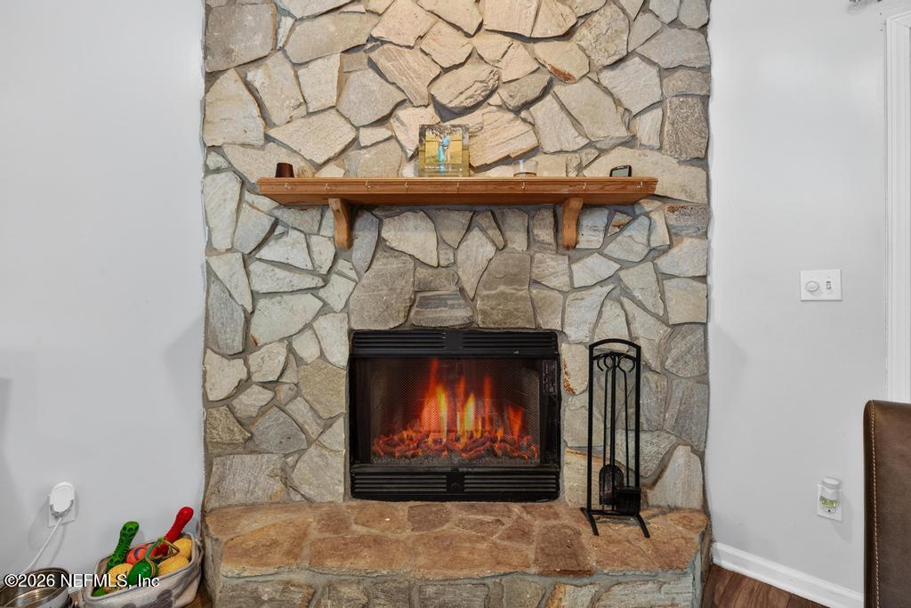 86093 Santa Barbara Street Yulee, FL 32097 - Photo 27 of 51 a fireplace with a clock on wall