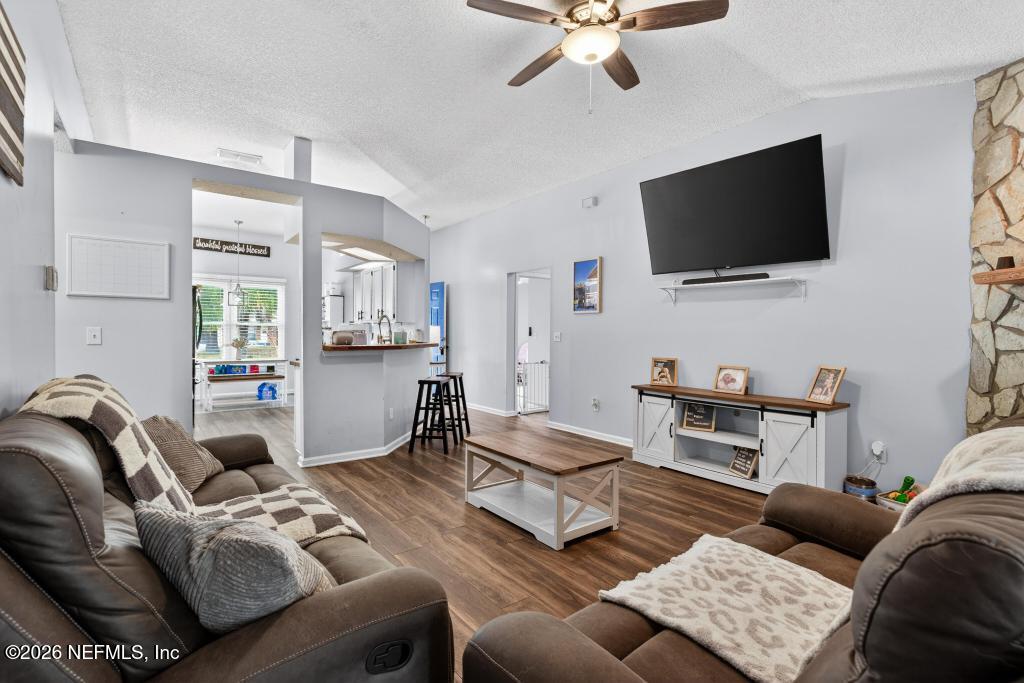 86093 Santa Barbara Street Yulee, FL 32097 - Photo 28 of 51 a living room with furniture and a flat screen tv