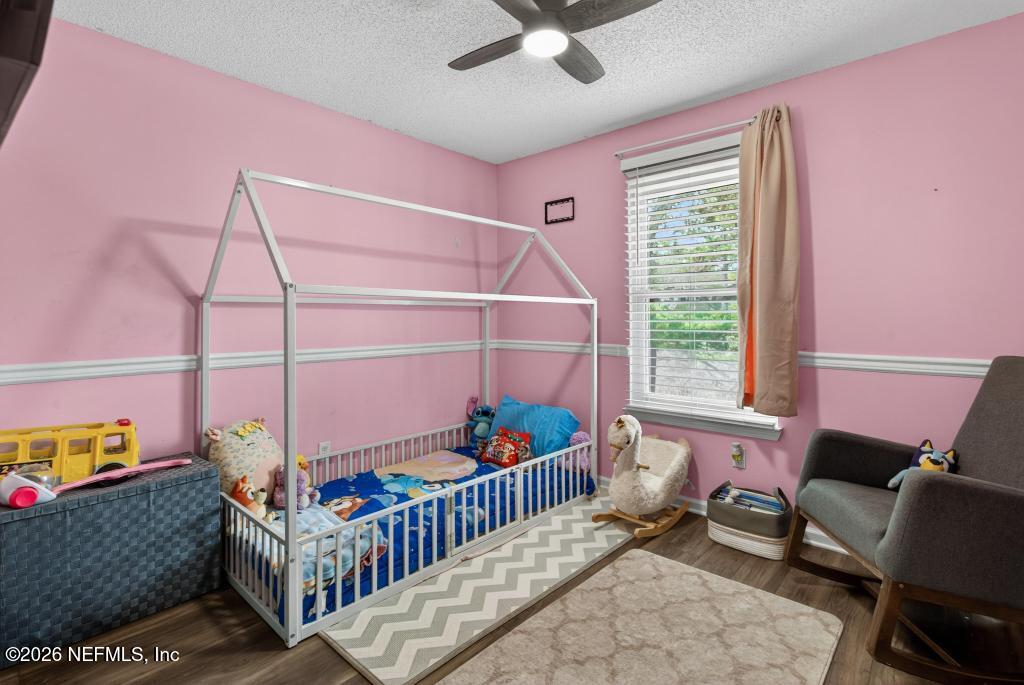 86093 Santa Barbara Street Yulee, FL 32097 - Photo 29 of 51 a bedroom with furniture and a window