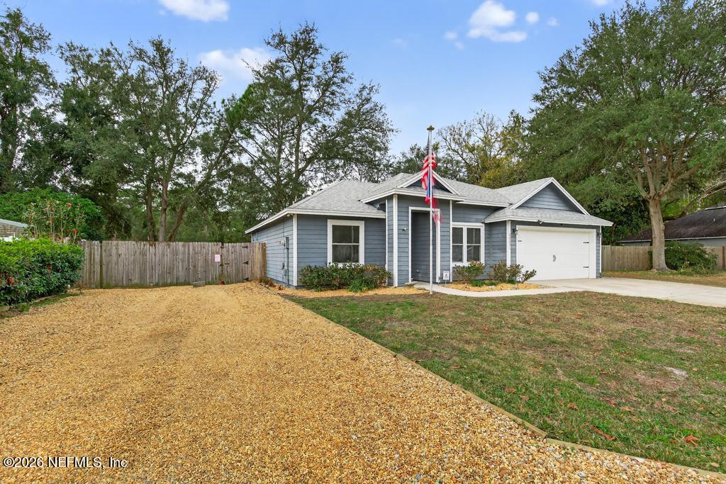 86093 Santa Barbara Street Yulee, FL 32097 - Photo 3 of 51 a front view of a house with yard