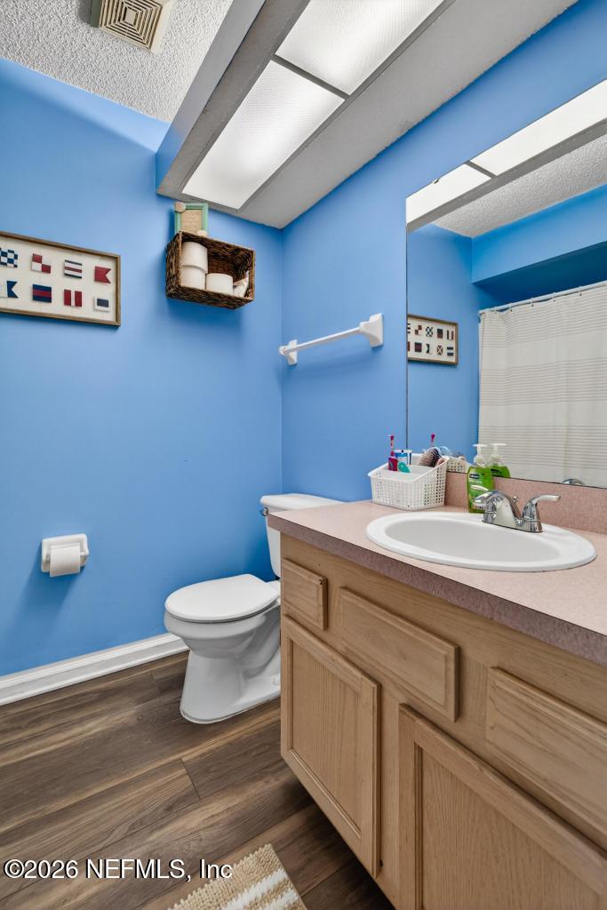 86093 Santa Barbara Street Yulee, FL 32097 - Photo 32 of 51 a bathroom with a sink mirror and toilet