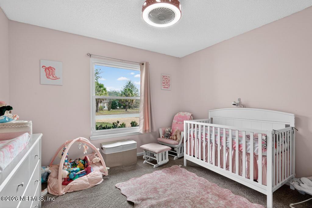 86093 Santa Barbara Street Yulee, FL 32097 - Photo 33 of 51 a bedroom with a bed and a window
