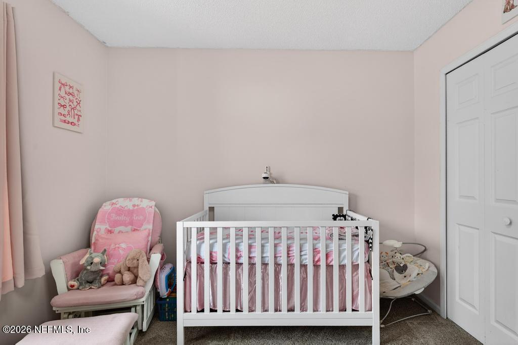 86093 Santa Barbara Street Yulee, FL 32097 - Photo 34 of 51 a bedroom with a bed and a window