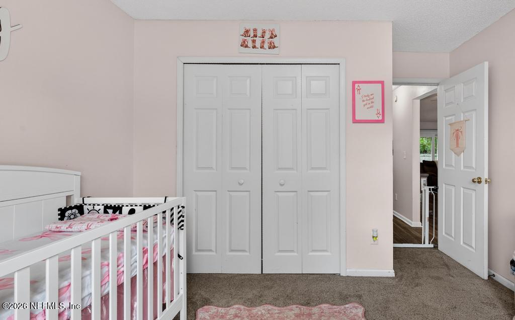 86093 Santa Barbara Street Yulee, FL 32097 - Photo 35 of 51 a view of a baby room with a baby crib