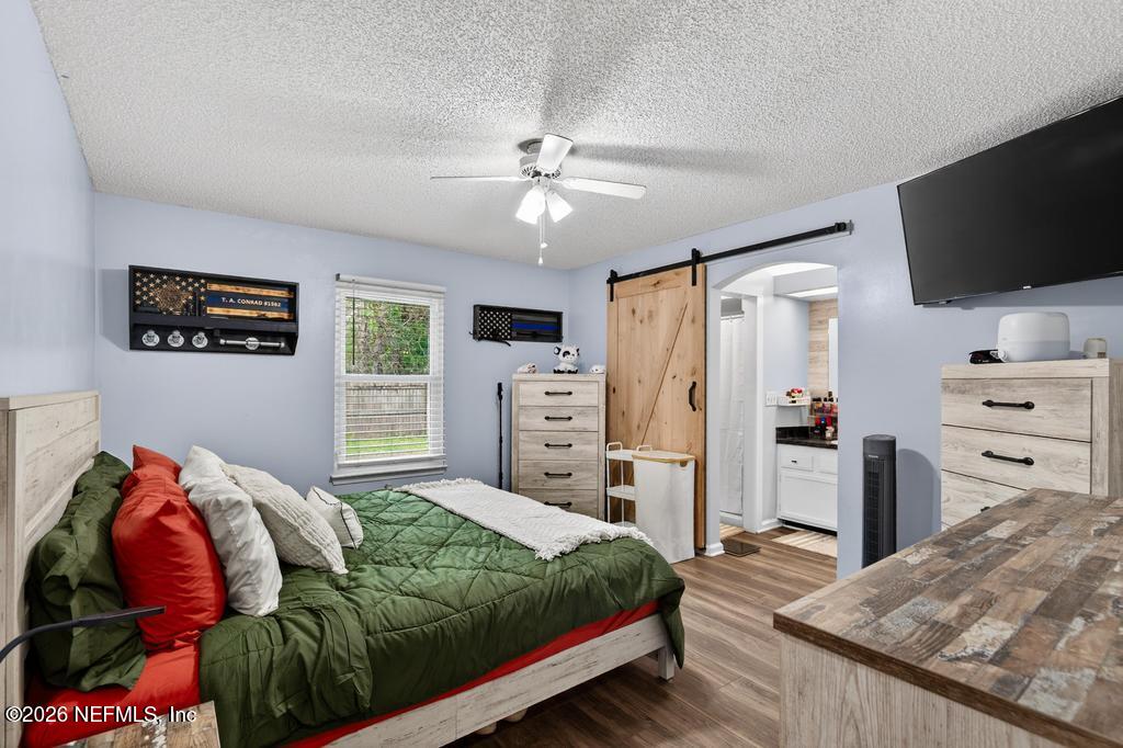 86093 Santa Barbara Street Yulee, FL 32097 - Photo 36 of 51 a bedroom with a bed and flat screen tv