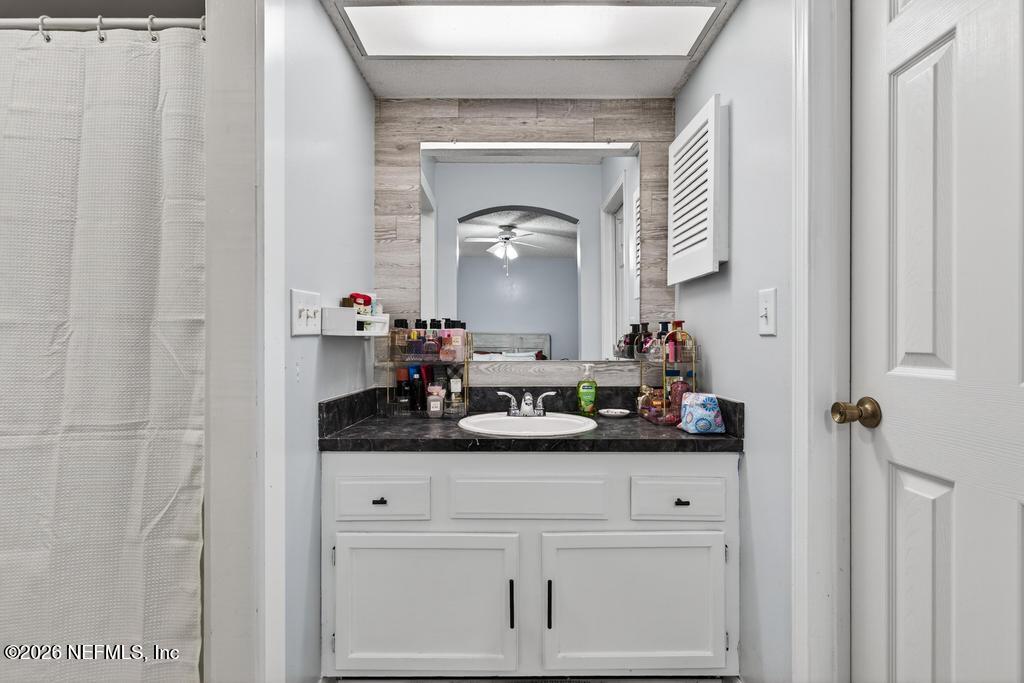 86093 Santa Barbara Street Yulee, FL 32097 - Photo 41 of 51 a bathroom with a sink and a mirror