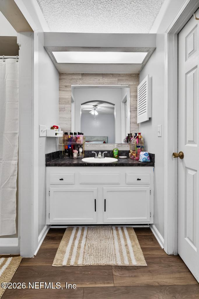 86093 Santa Barbara Street Yulee, FL 32097 - Photo 42 of 51 a bathroom with a mirror and vanity