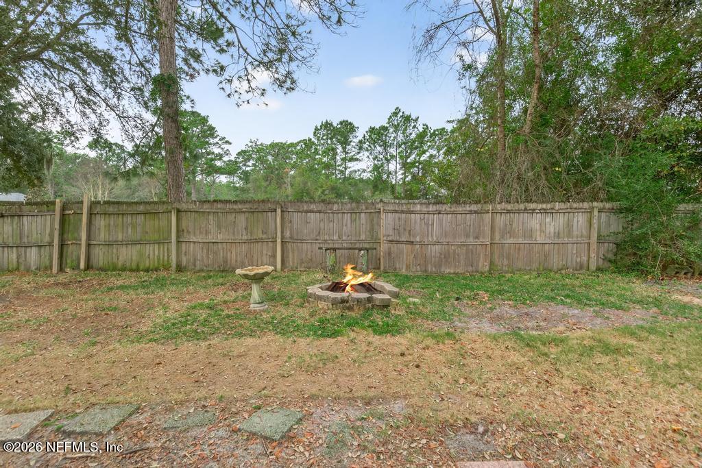 86093 Santa Barbara Street Yulee, FL 32097 - Photo 49 of 51 a backyard of a house with trampoline