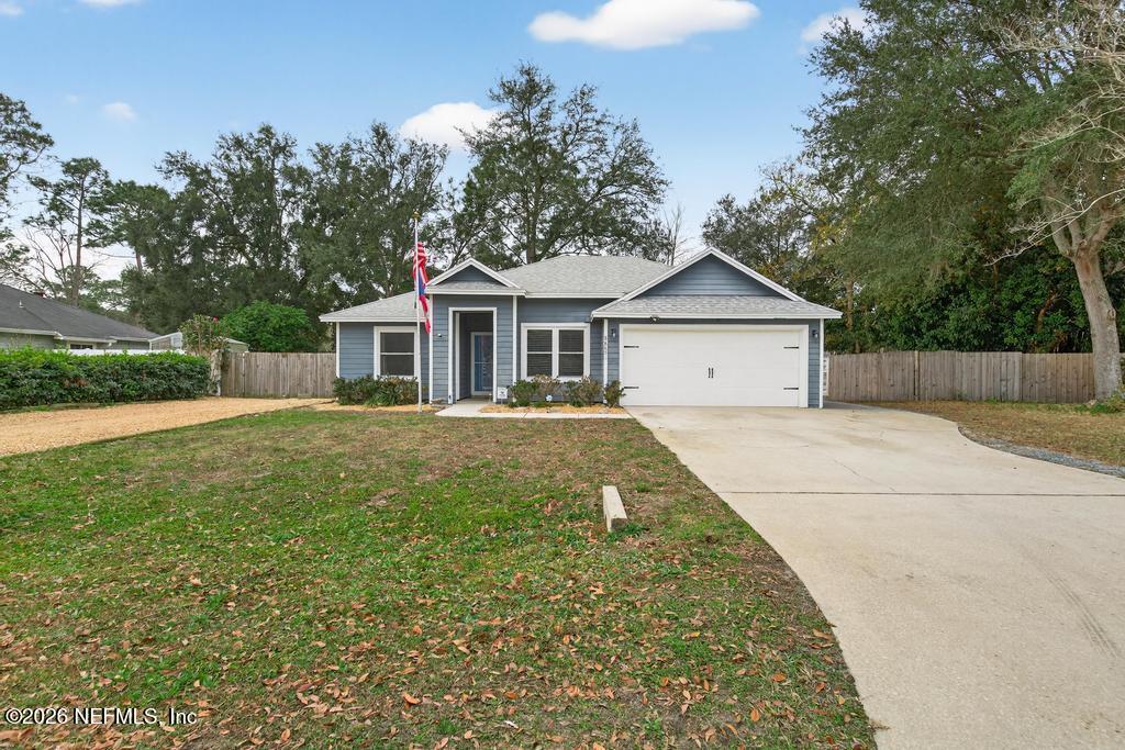 86093 Santa Barbara Street Yulee, FL 32097 - Photo 5 of 51 a front view of a house with a garden
