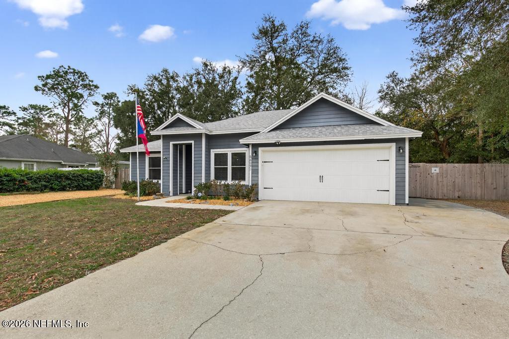 86093 Santa Barbara Street Yulee, FL 32097 - Photo 8 of 51 a house with trees in the background