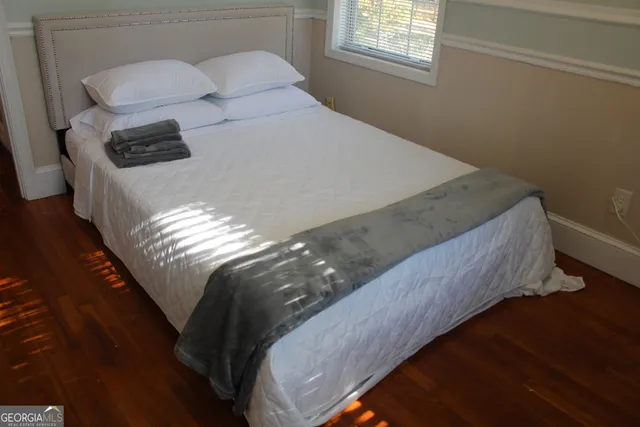 a bed sitting in a bedroom next to a window