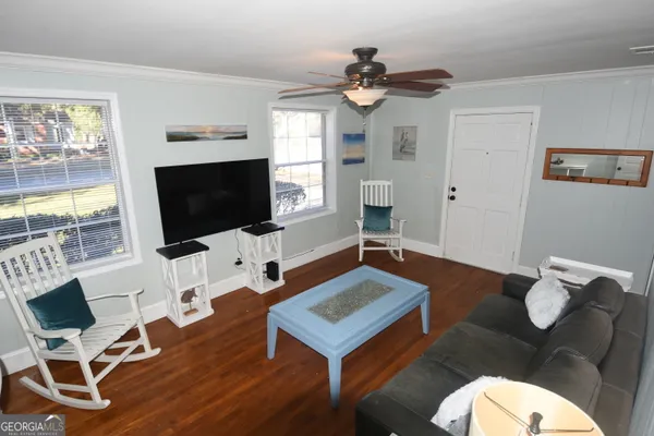 a living room with furniture and a flat screen tv