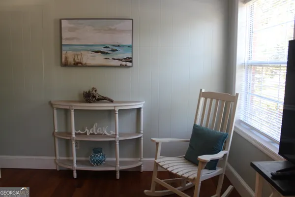 a view of a workspace with furniture and a window