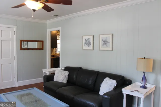 a living room with furniture and a lamp