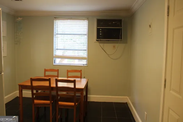 a view of a dining room with furniture and window