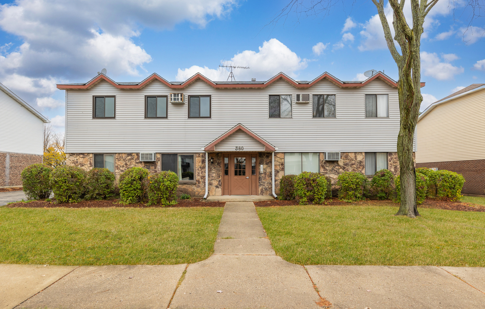 380 Echo Lane, Unit 3 Aurora, IL 60504 - Photo 1 of 1 a front view of a house with yard and green space