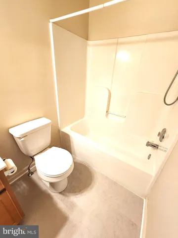 a white toilet sitting next to a bathroom sink