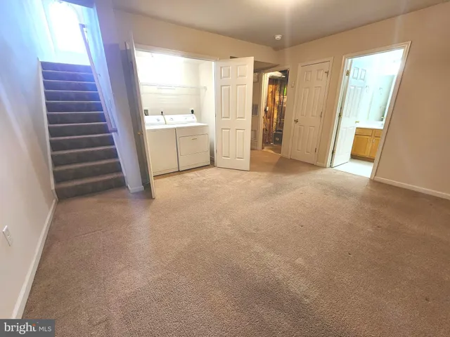 a view of an empty room with a fireplace and a window