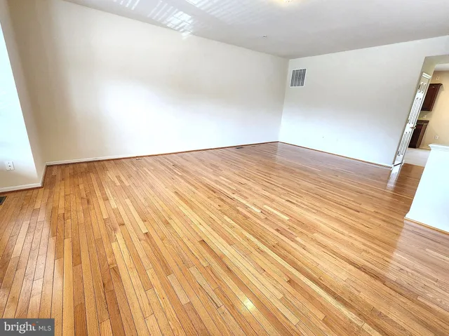 a view of wooden floor and brick walls