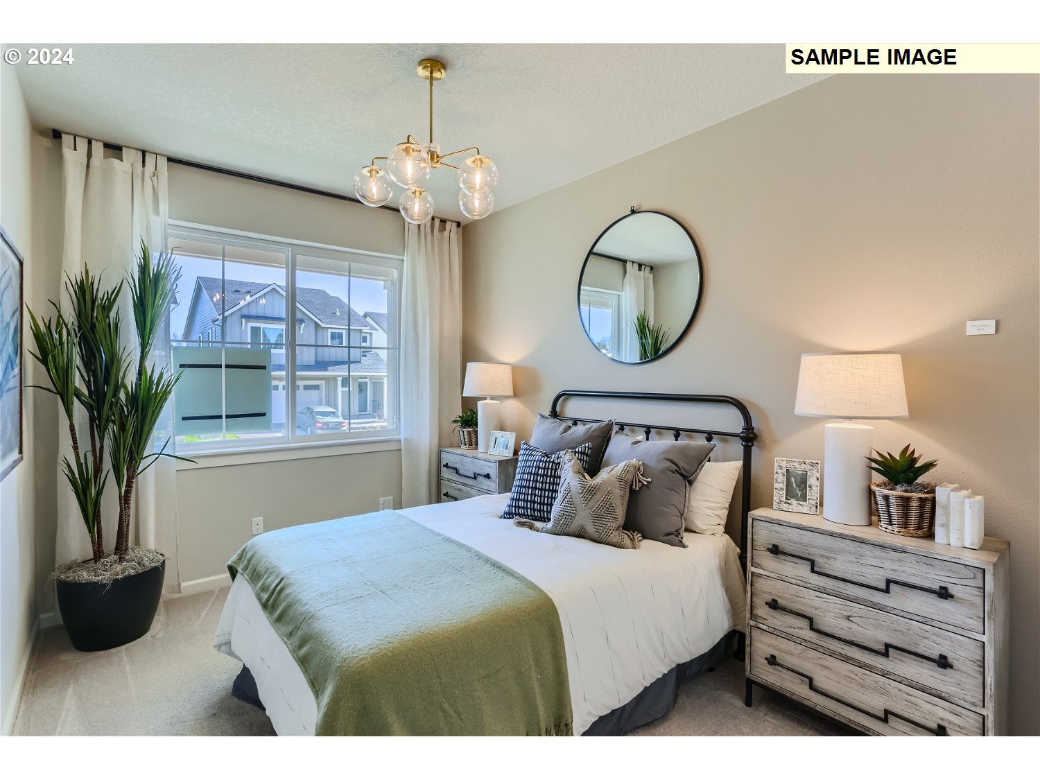 12535 Southwest Lapwing Terrace Beaverton, OR 97007 - Photo 11 of 29 a bedroom with a bed a mirror and lamp