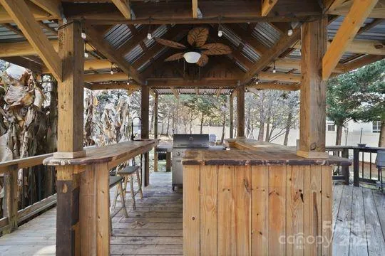 a view of a roof deck with wooden floor and outdoor seating