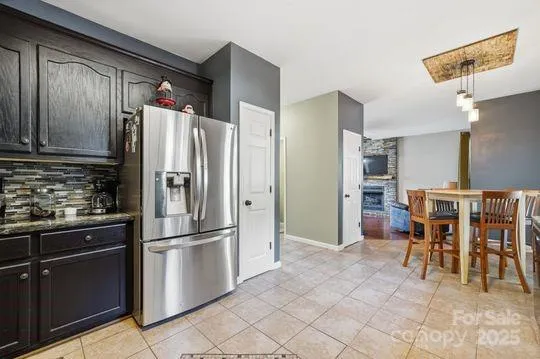 a kitchen with stainless steel appliances granite countertop a refrigerator and a stove top oven