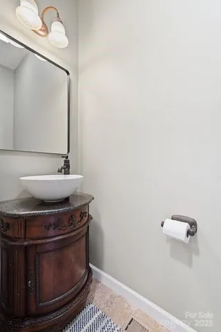 a room with a sink and a mirror