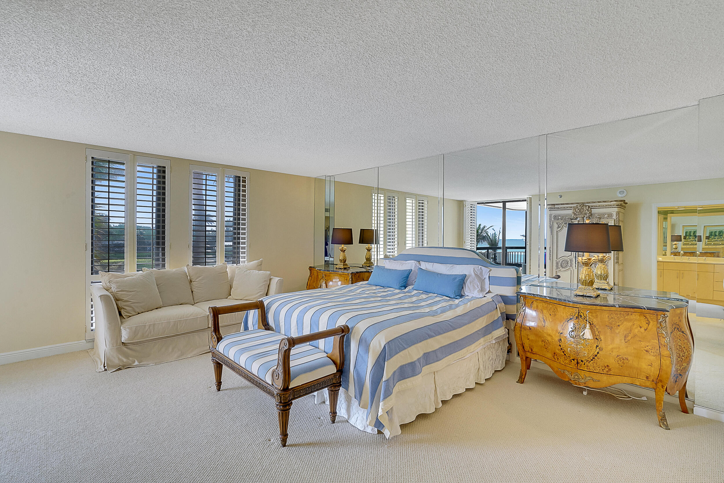 5380 North Ocean Drive, Unit 2I Singer Island, FL 33404 - Photo 11 of 32 a spacious bedroom with a bed a couch and a large window
