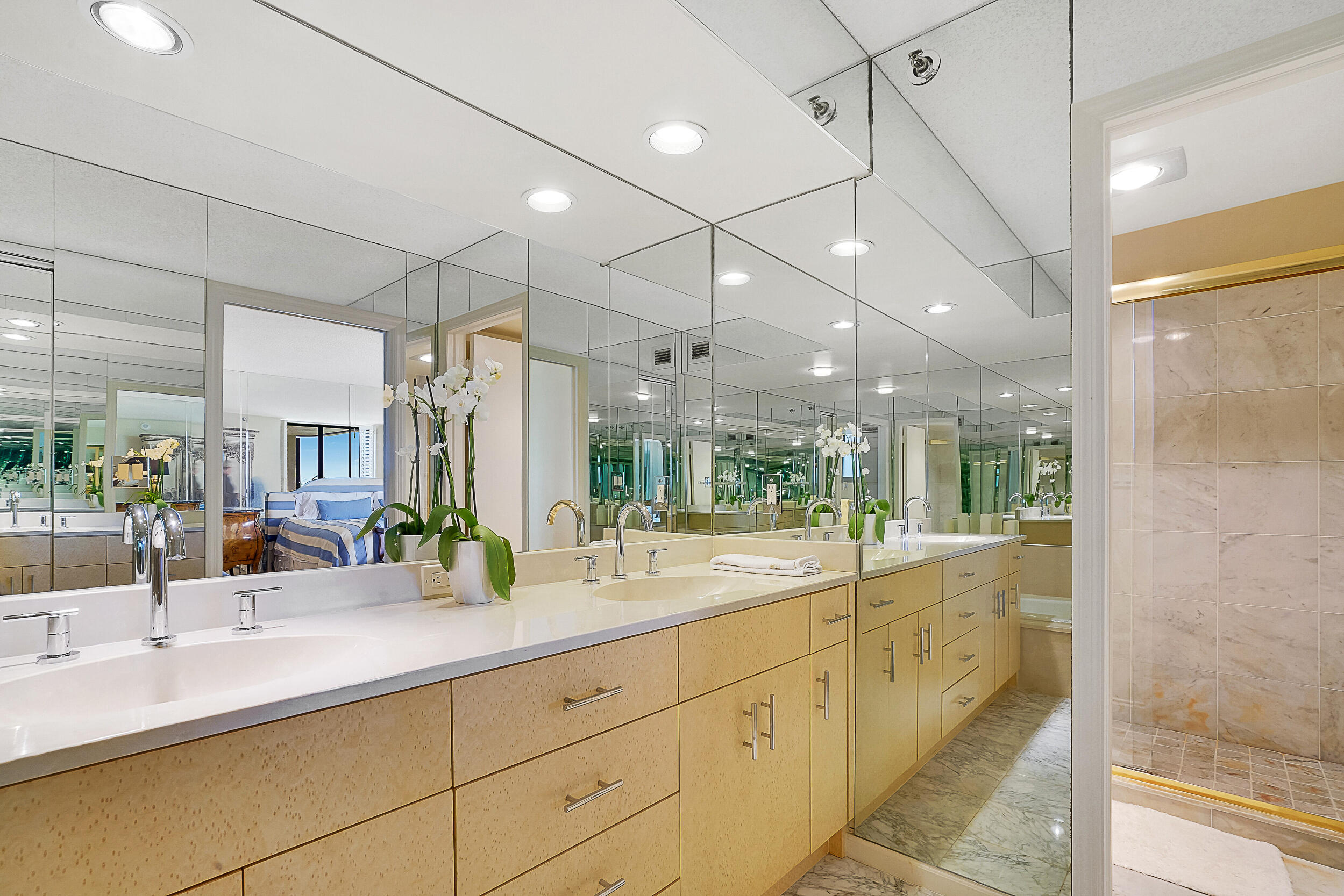 5380 North Ocean Drive, Unit 2I Singer Island, FL 33404 - Photo 17 of 32 a large bathroom with a double vanity sink and a large mirror