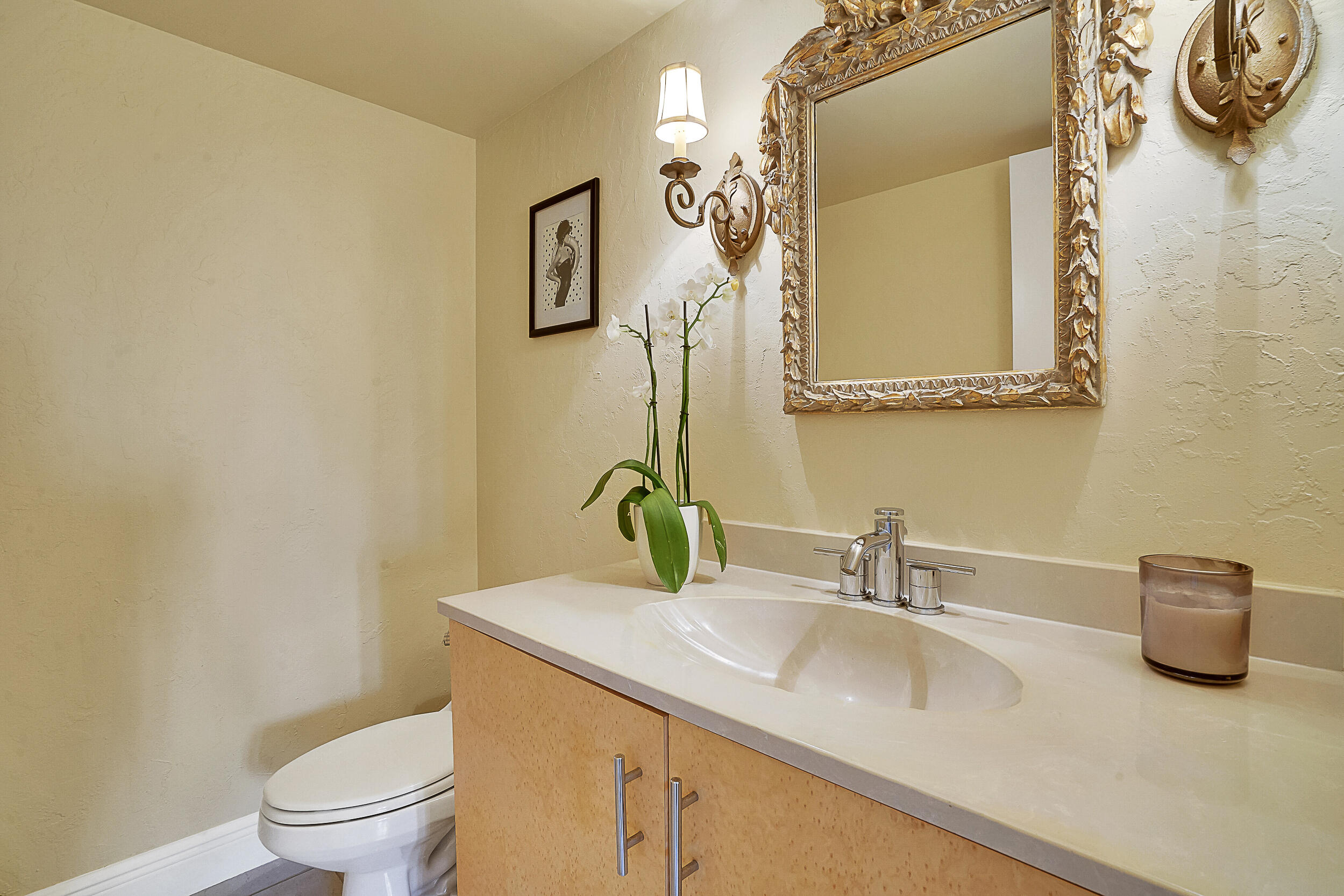 5380 North Ocean Drive, Unit 2I Singer Island, FL 33404 - Photo 18 of 32 a bathroom with a granite countertop sink a toilet and a mirror
