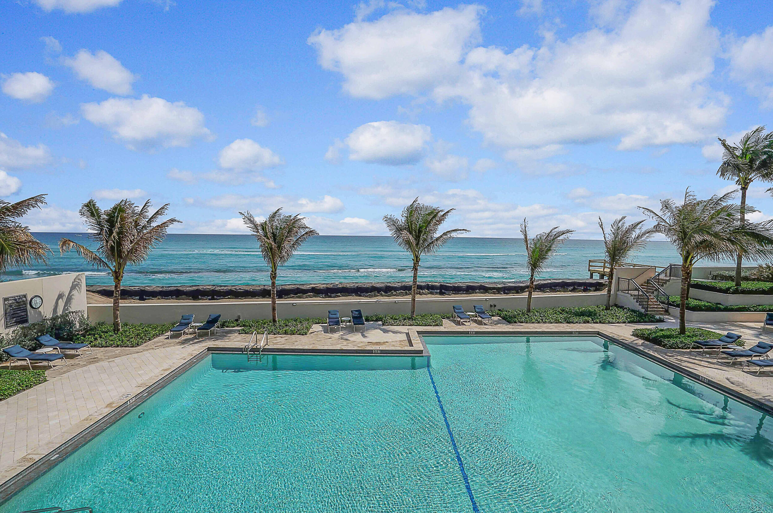 5380 North Ocean Drive, Unit 2I Singer Island, FL 33404 - Photo 19 of 32 a view of swimming pool with outdoor seating and ocean view