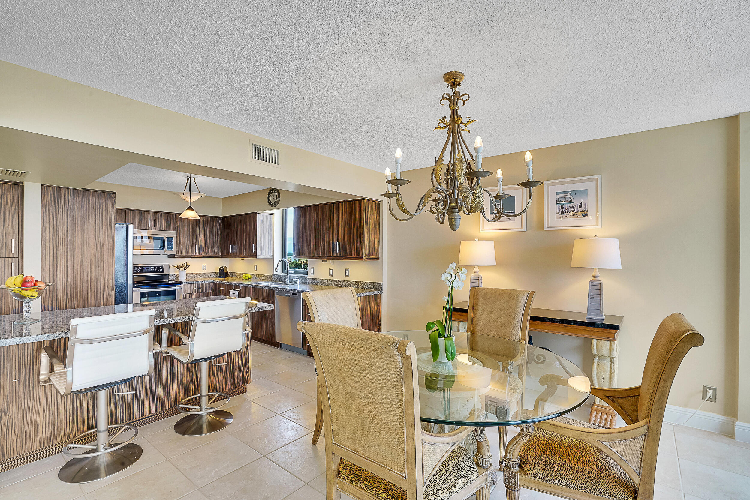 5380 North Ocean Drive, Unit 2I Singer Island, FL 33404 - Photo 6 of 32 a view of a dining room with furniture and chandelier