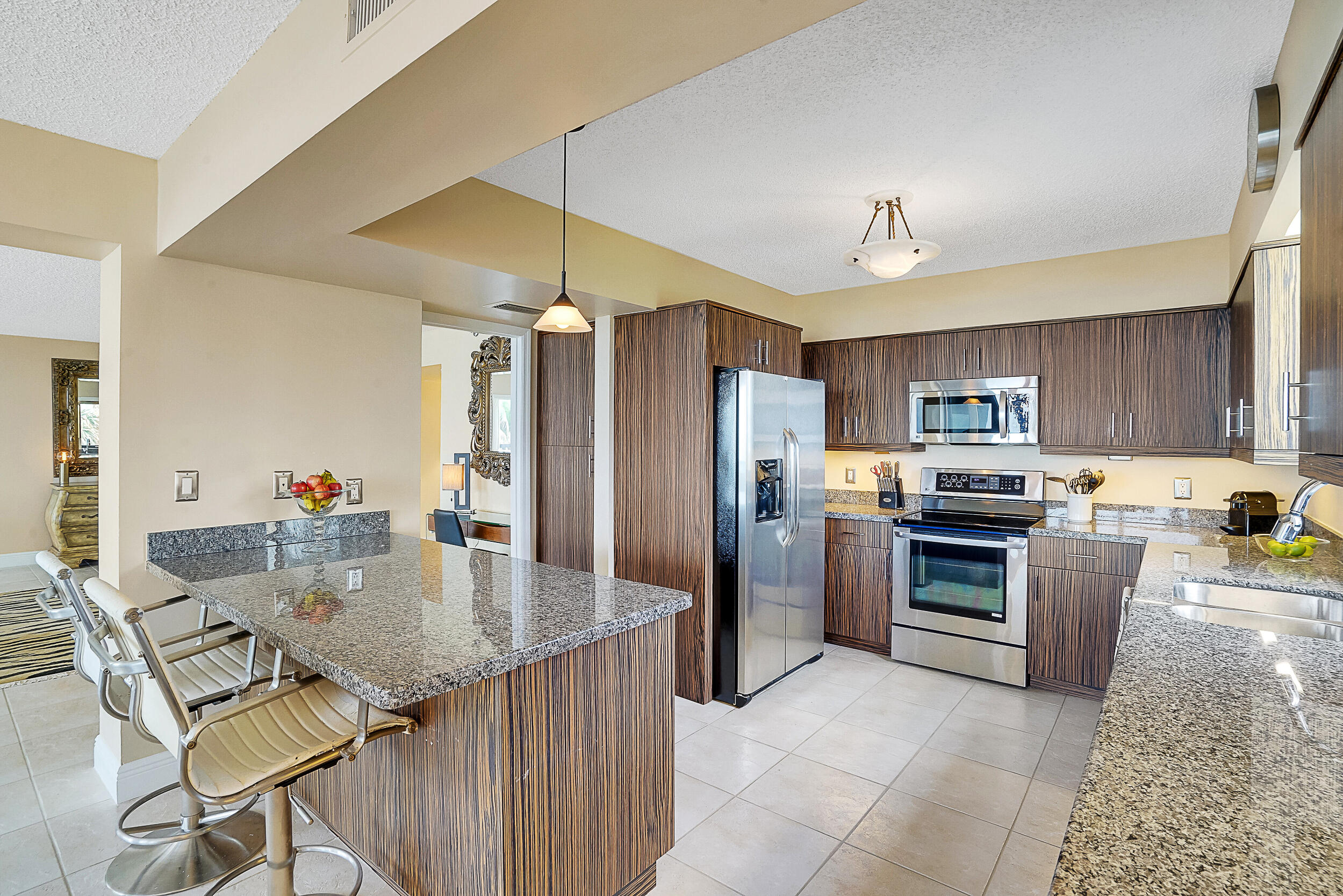 5380 North Ocean Drive, Unit 2I Singer Island, FL 33404 - Photo 7 of 32 a kitchen with stainless steel appliances granite countertop a sink refrigerator and cabinets