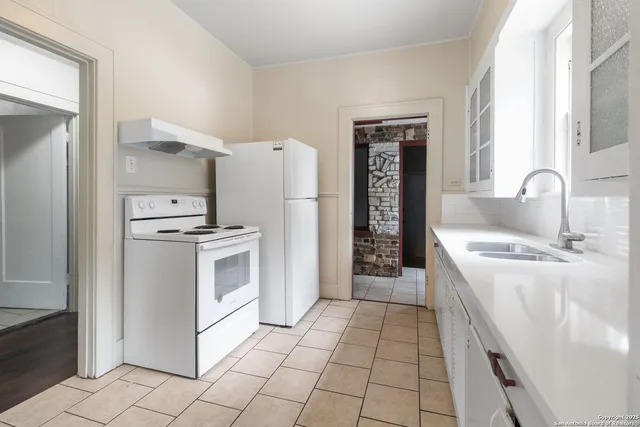 a kitchen with a sink a stove and refrigerator
