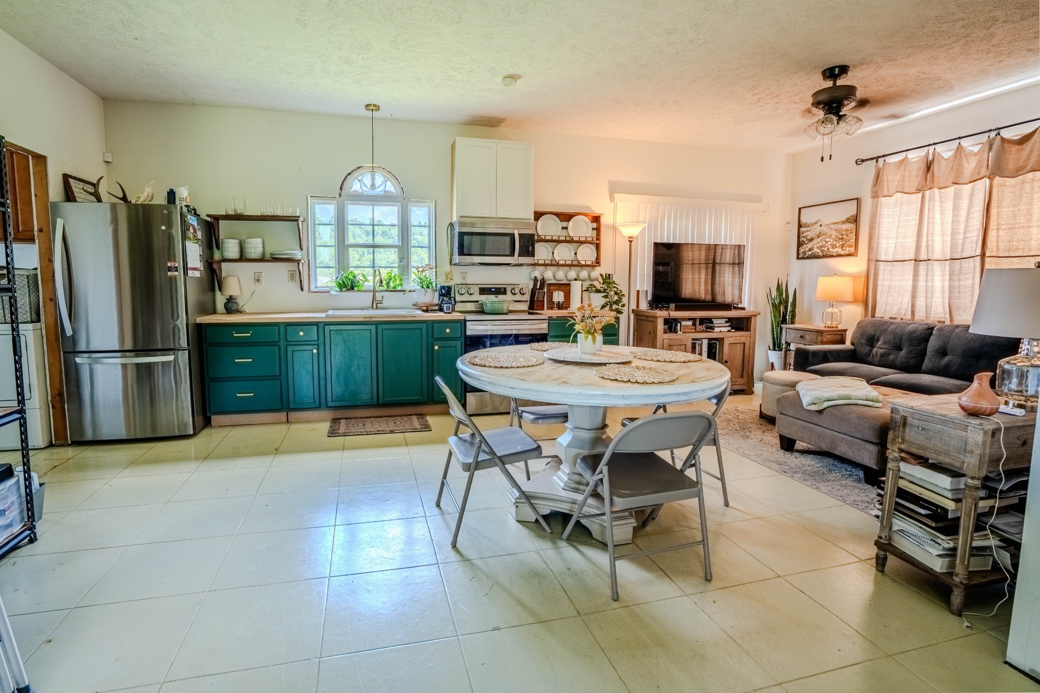 2461 Bodenham Road Pulaski, TN 38478 - Photo 49 of 59 a kitchen with a table chairs refrigerator and microwave