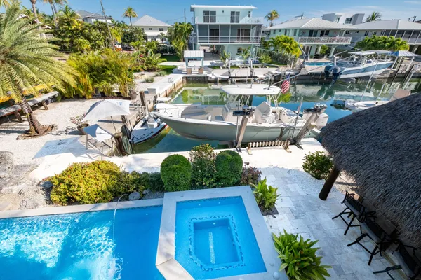 a bedroom with a bed a dresser and window