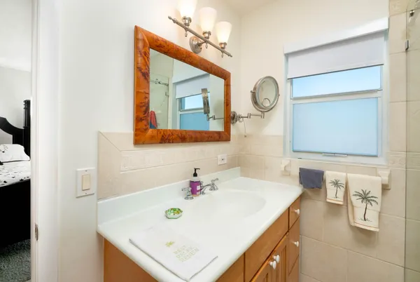 a bedroom with a bed and a mirror on dresser