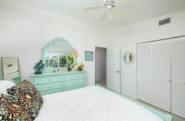 a living room with furniture a ceiling fan and a rug