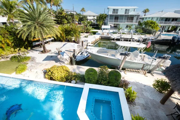 a utility room with stainless steel appliances granite countertop a sink and cabinets