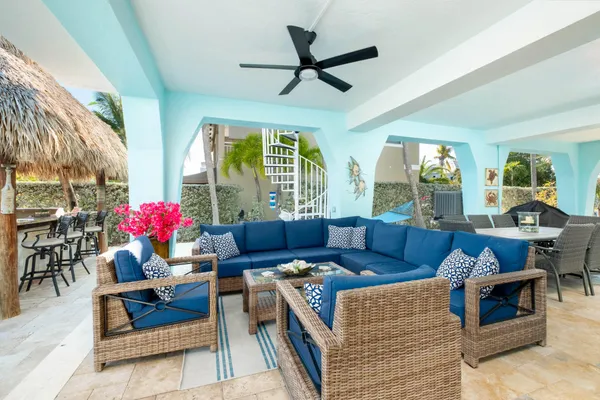 a living room with furniture a flat screen tv and a large window