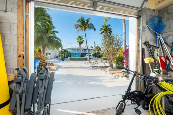 a living room with furniture a rug and a floor to ceiling window