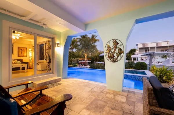a view of a patio with chairs potted plants