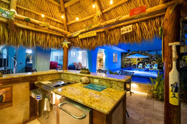 a view of a house with swimming pool and sitting area