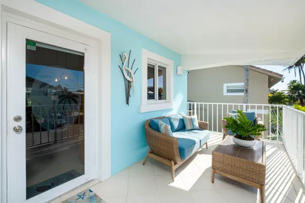 a large living room with stainless steel appliances kitchen island granite countertop furniture and a large window