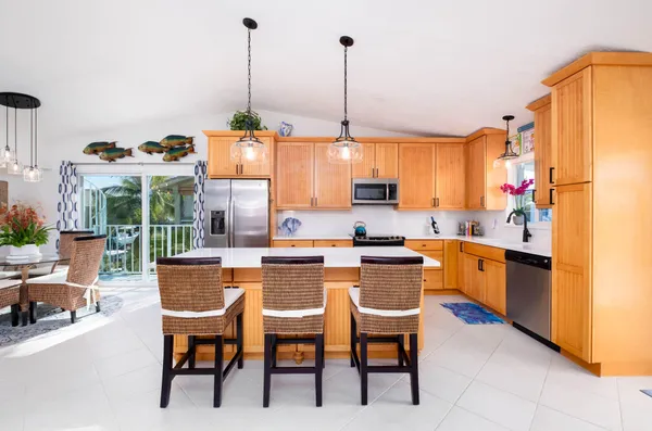 a dining room with furniture water view and a floor to ceiling window